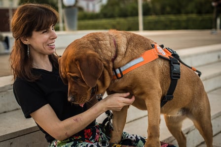 Blind woman happy support dog outside independence playing