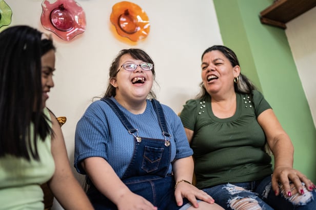 Friends together laughing down syndrome women happy diverse