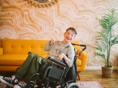 Man wheelchair happy bright disability lounge room